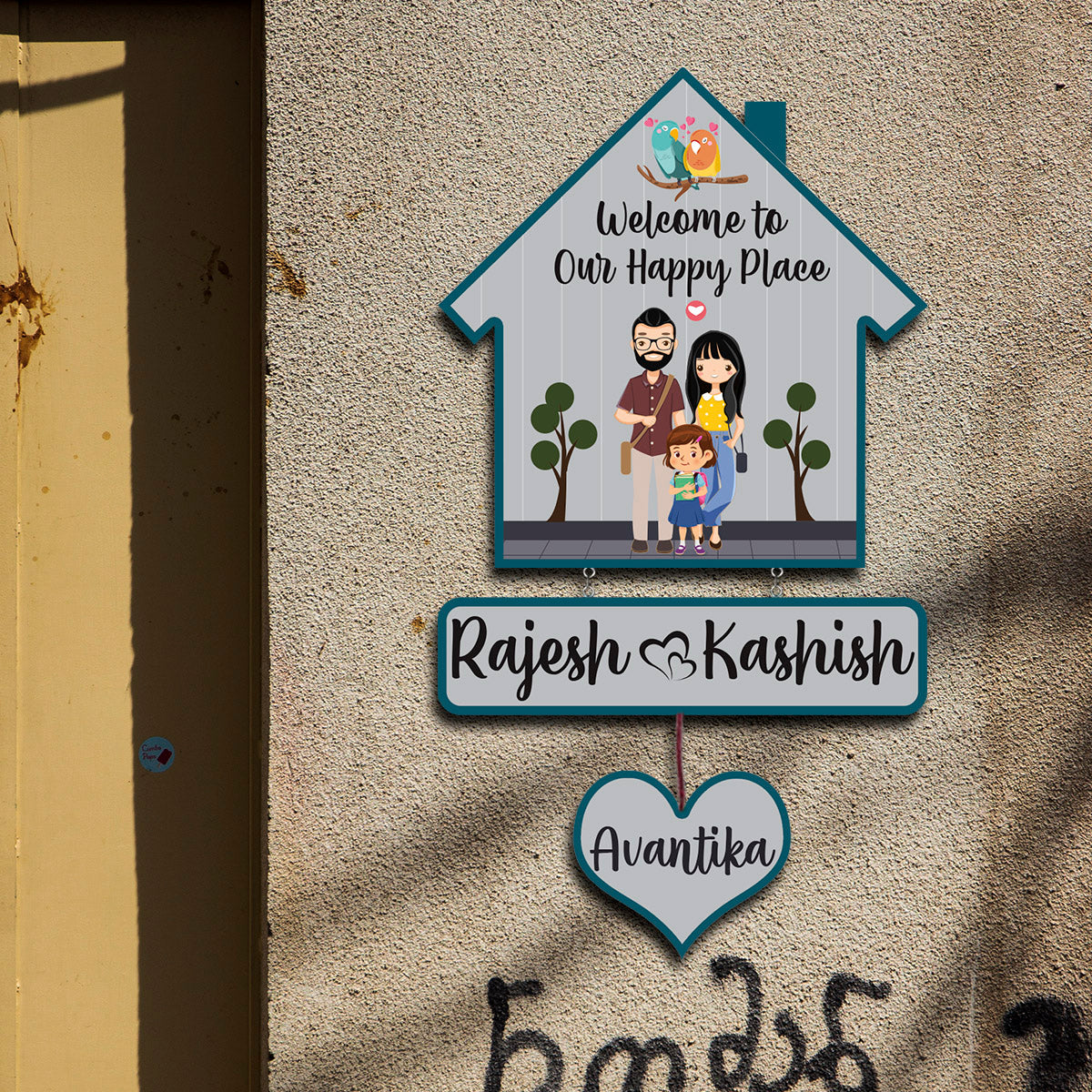 Close-up of lovebirds and welcome text on bird hut family name plate
