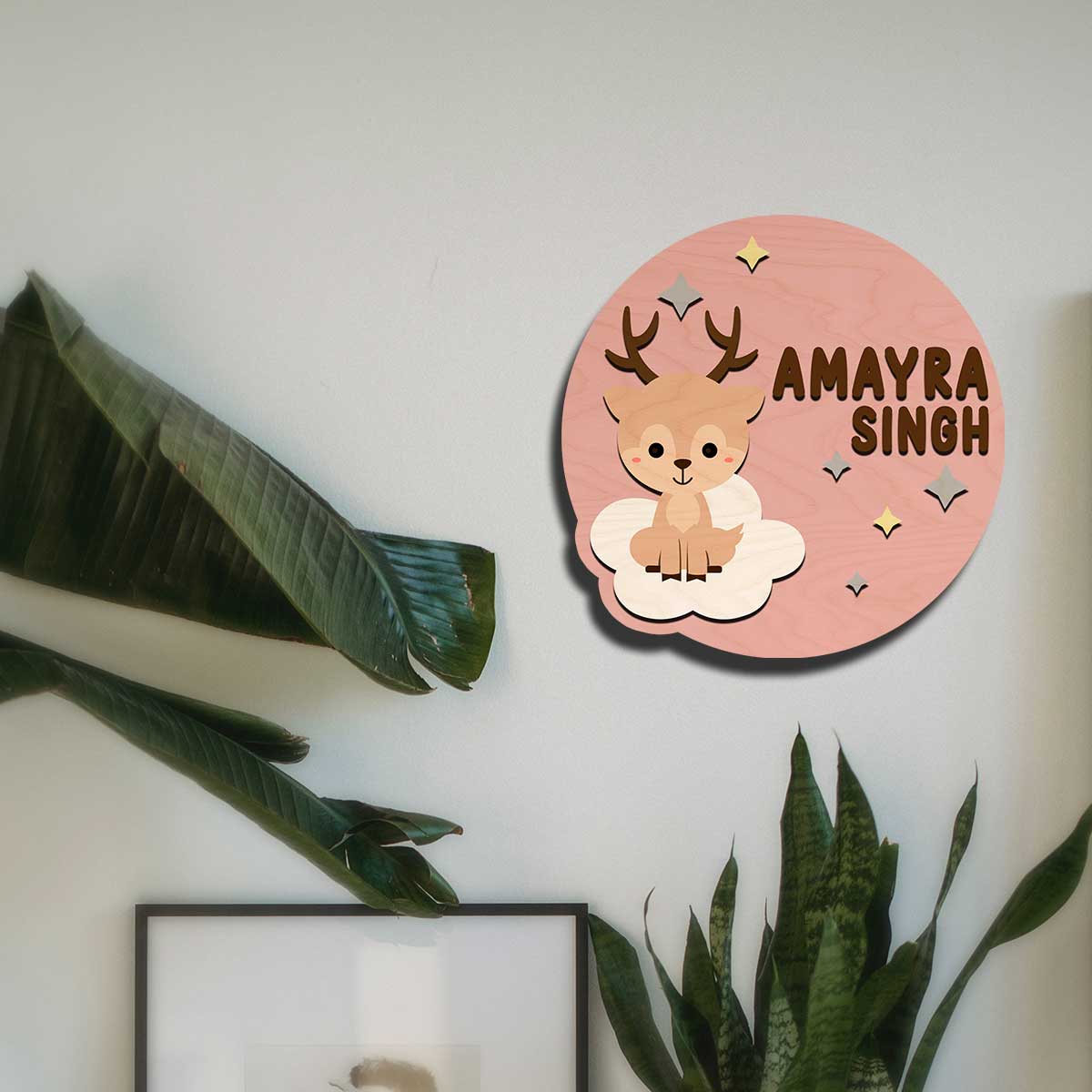 Close-up of baby deer with antlers and sparkle stars on pink deer name plate for kids