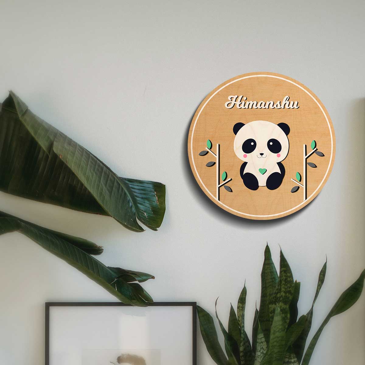 Round panda kids name plate on a bedroom door with a child's name in white script