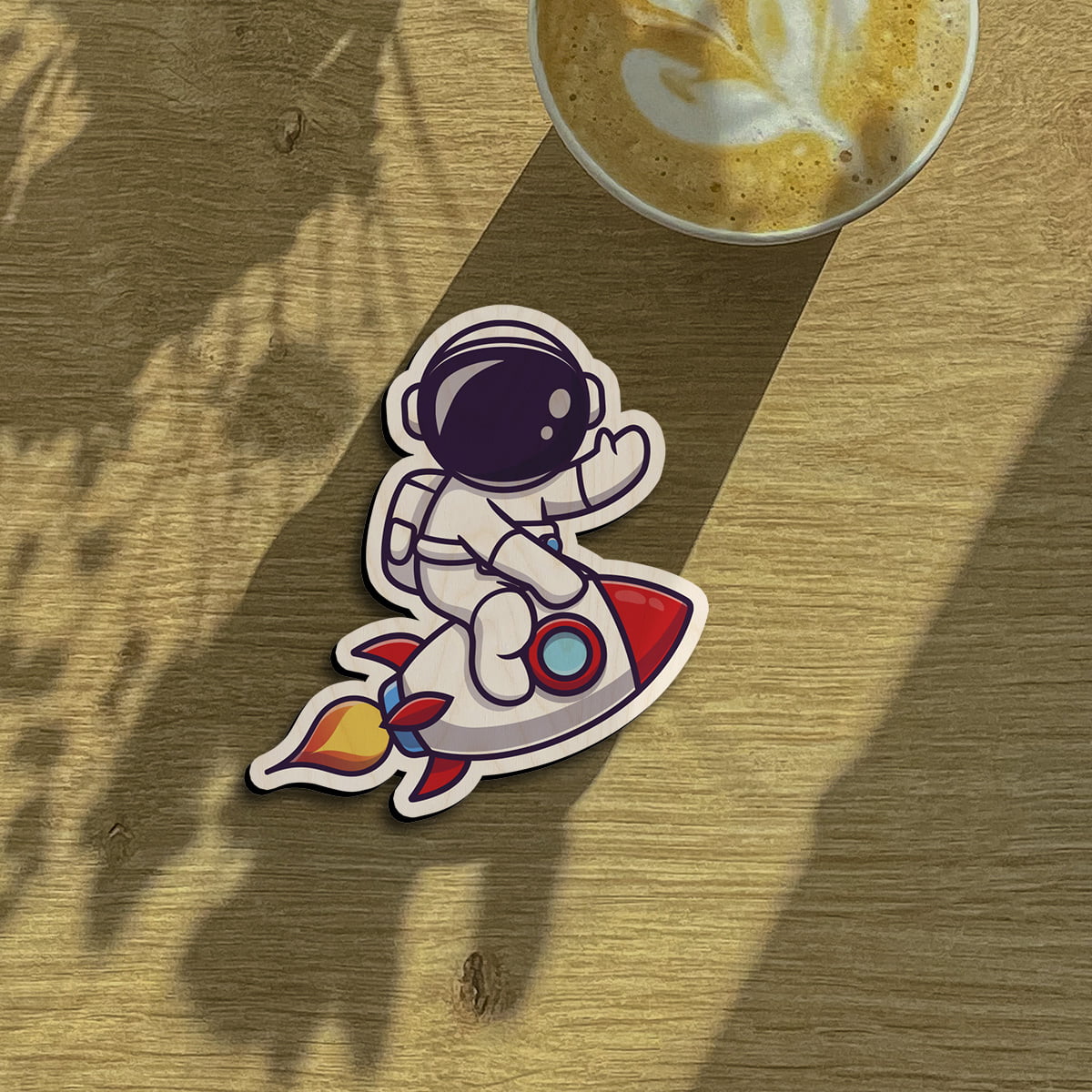 Kids fridge magnet on a clean backdrop showing cartoon astronaut on red rocket with flame trail.