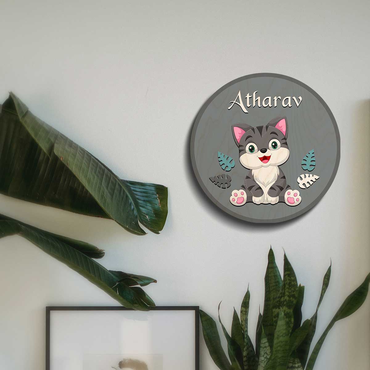 Round grey cat name plate for kids on bedroom door with teal leaf cutouts