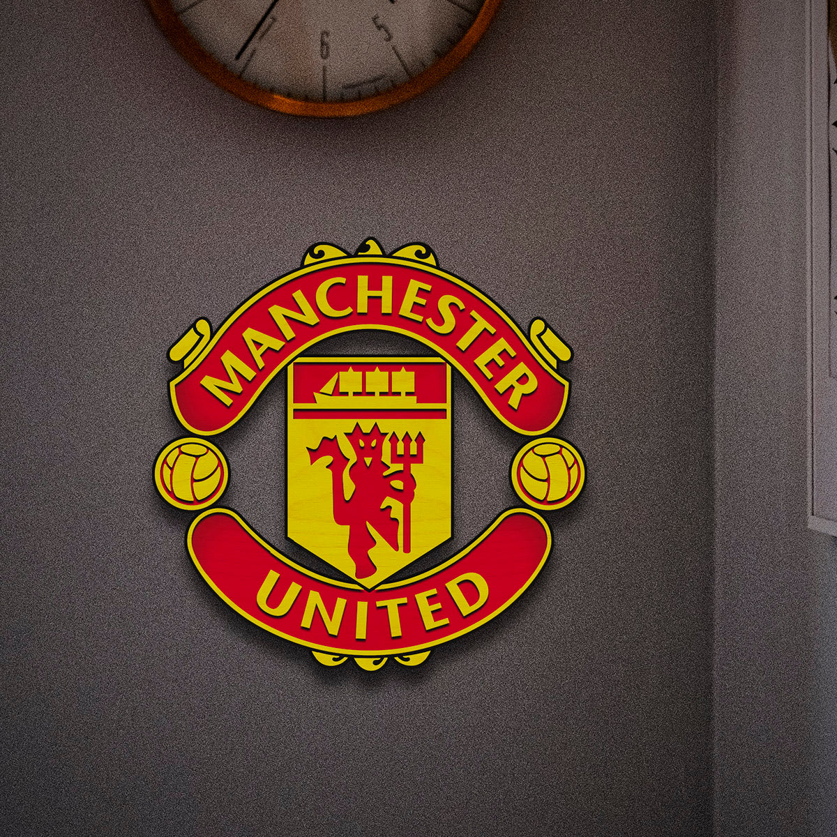 Manchester United wooden crest – handcrafted 3D Red Devils club crest in laser-cut birch, mounted on a grey wall