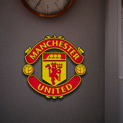 Manchester United wooden crest – handcrafted 3D Red Devils club crest in laser-cut birch, mounted on a grey wall
