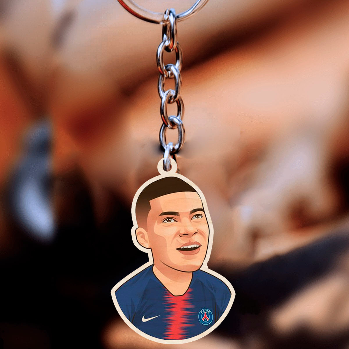 Football keychain on a clean backdrop showing mbappe cartoon in PSG navy + red center-stripe kit with.