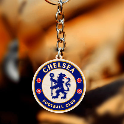 Football keychain on a clean backdrop showing chelsea blue rampant lion roundel with gold ring text.