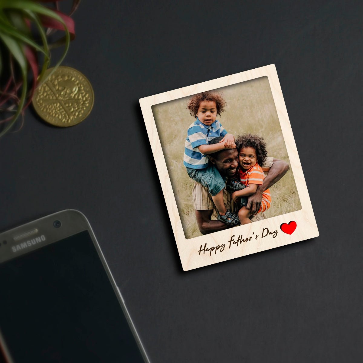 Alternate angle on the dad fridge magnet, showing polaroid with 'Happy Father's Day' cursive, in birch wood.