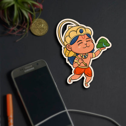Alternate angle on the god fridge magnet, showing cartoon Hanuman with Sanjivani mountain and golden crown, in birch wood.