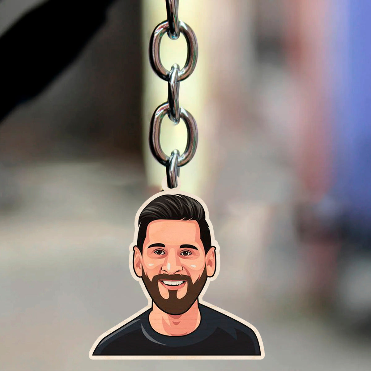 Front view of Messi keychain showing the cartoon bust face and metal split-ring attachment