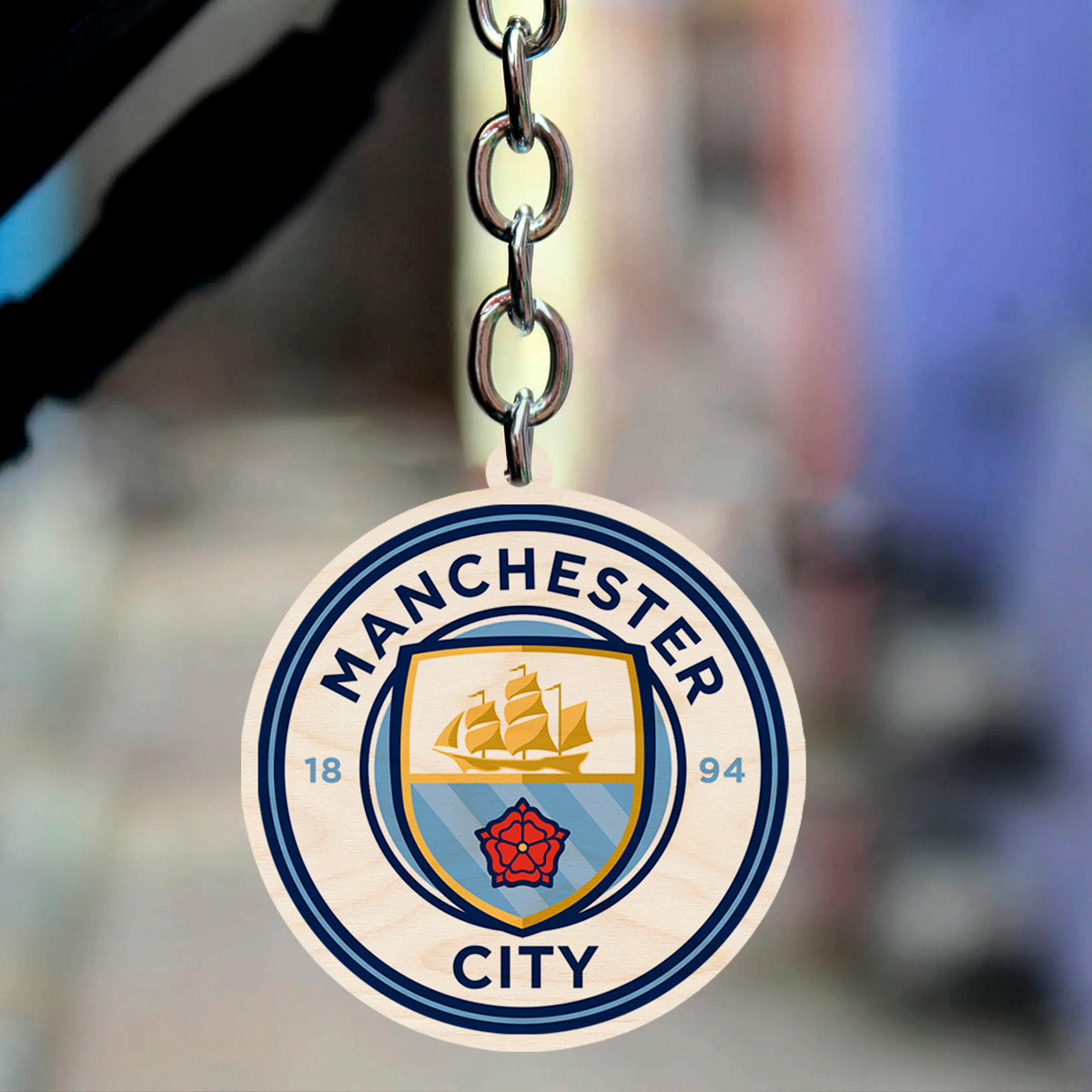 Football keychain on a clean backdrop showing light-blue ship + red rose roundel with 1894 founding date.