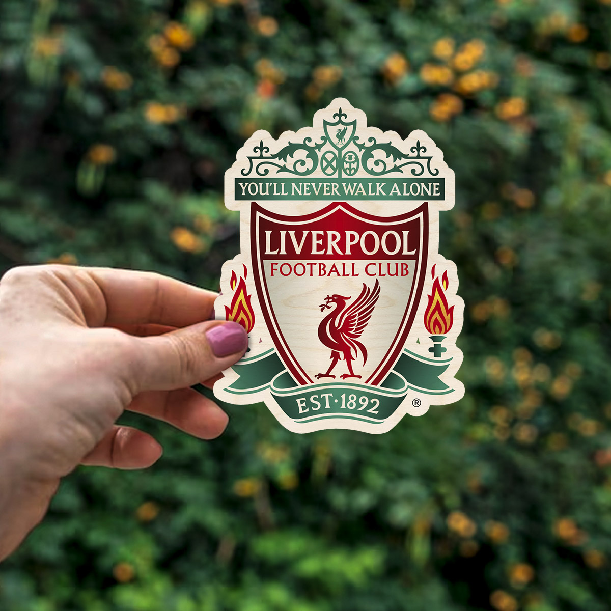 Detail crop of the liverpool fridge magnet, with full ornate Liverpool crest with YNWA, on birch wood face.