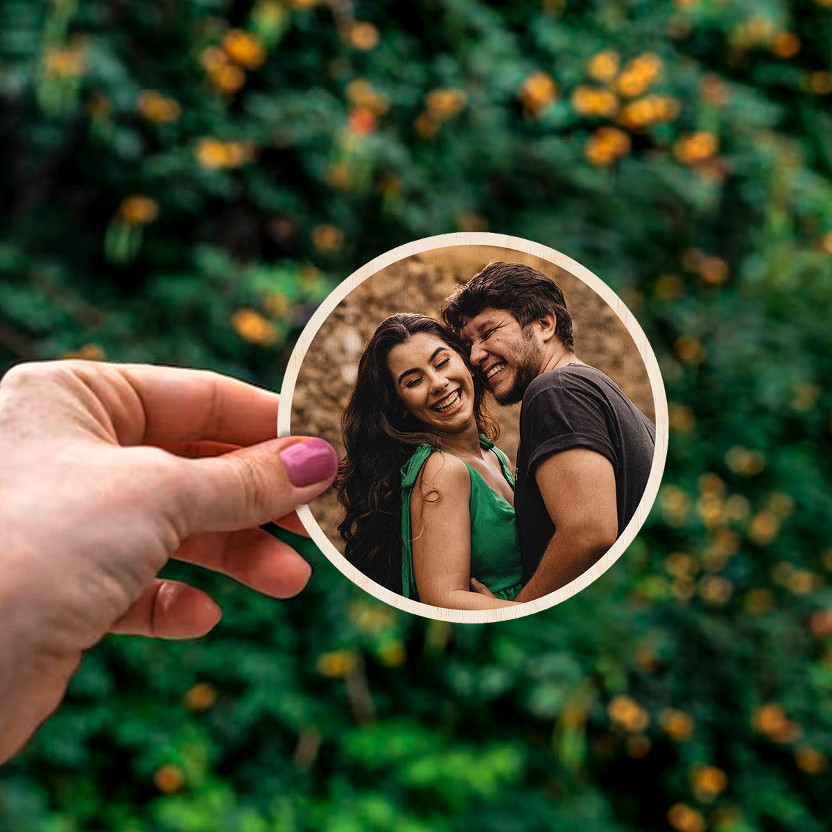 Detail crop of the couple fridge magnet, with circle contour-cut silhouette with full-bleed couple photo.