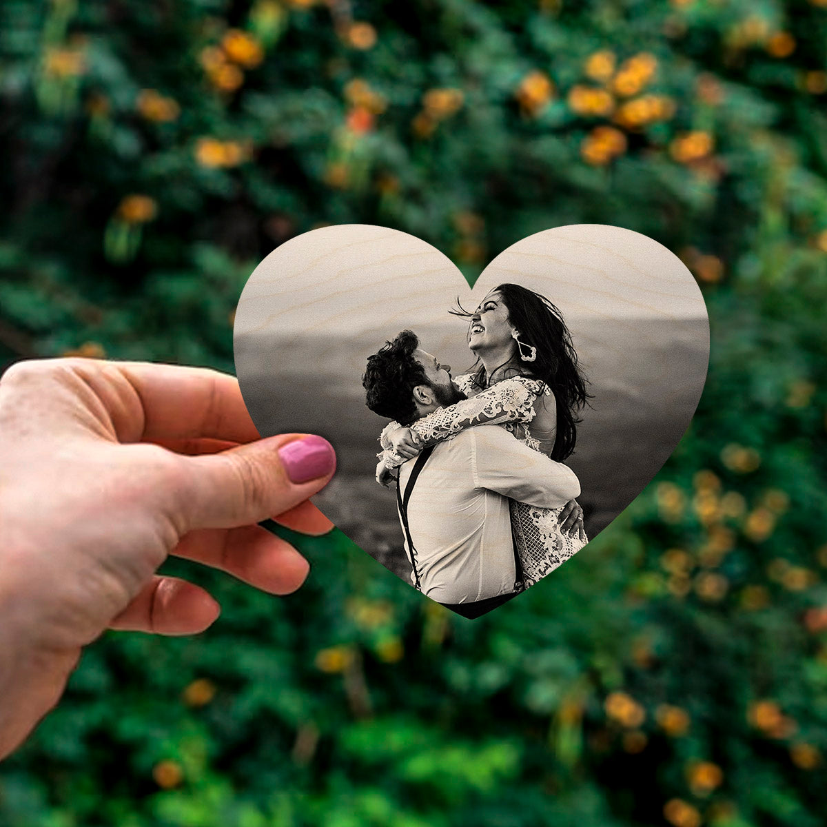 Detail crop of the couple fridge magnet, with heart contour-cut silhouette with full-bleed couple photo, on birch wood face.