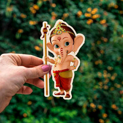 Detail crop of the god fridge magnet, with cartoon baby Ganesha with staff and tiara silhouette, on birch wood face.