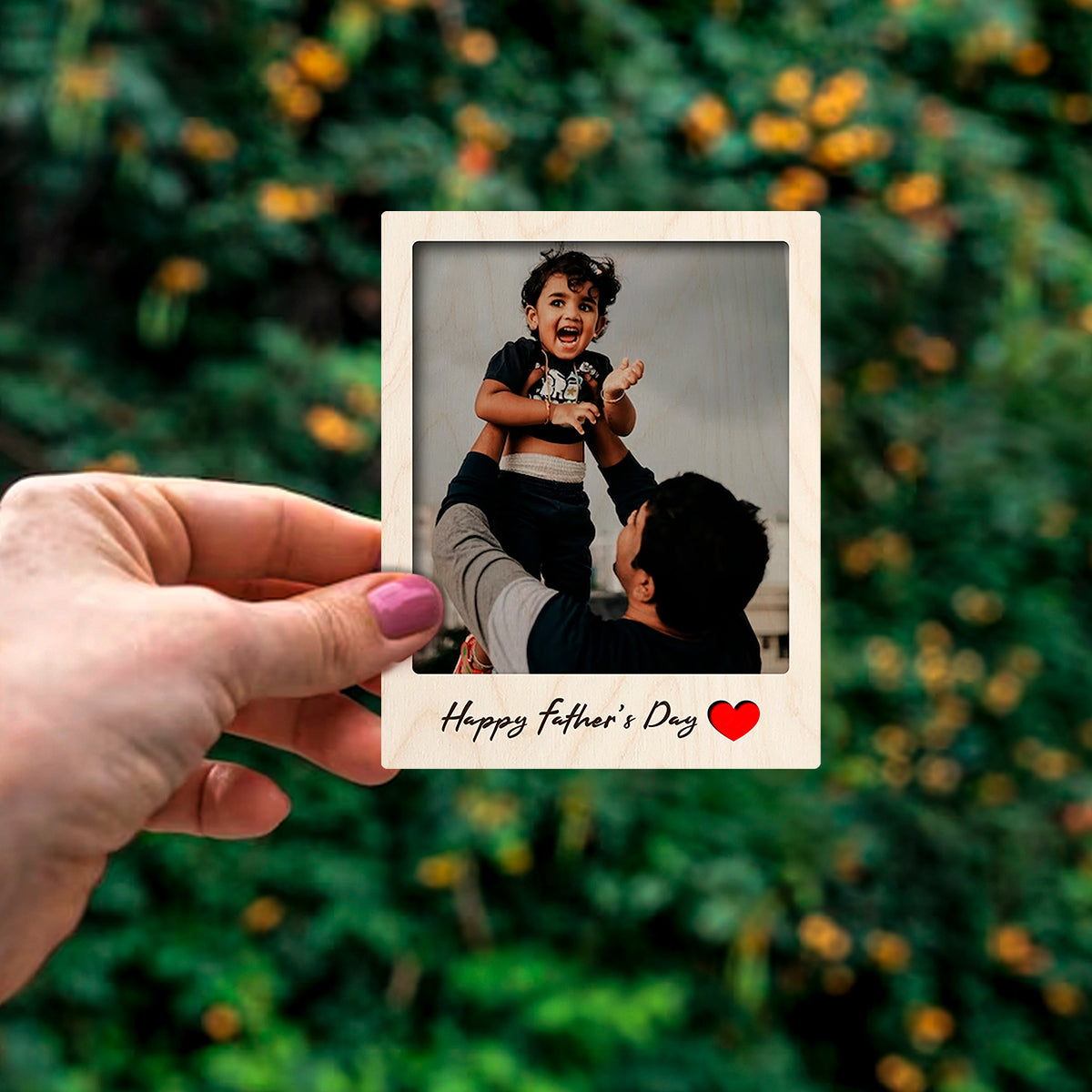 Detail crop of the dad fridge magnet, with polaroid with 'Happy Father's Day' cursive, on birch wood face.