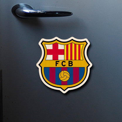 On-fridge lifestyle shot of the fc barcelona fridge magnet, showing fCB heraldic crest with Catalan flag.