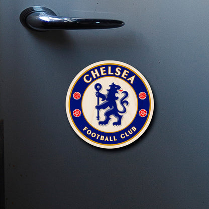 On-fridge lifestyle shot of the chelsea fridge magnet, showing chelsea blue rampant lion roundel with gold ring text.