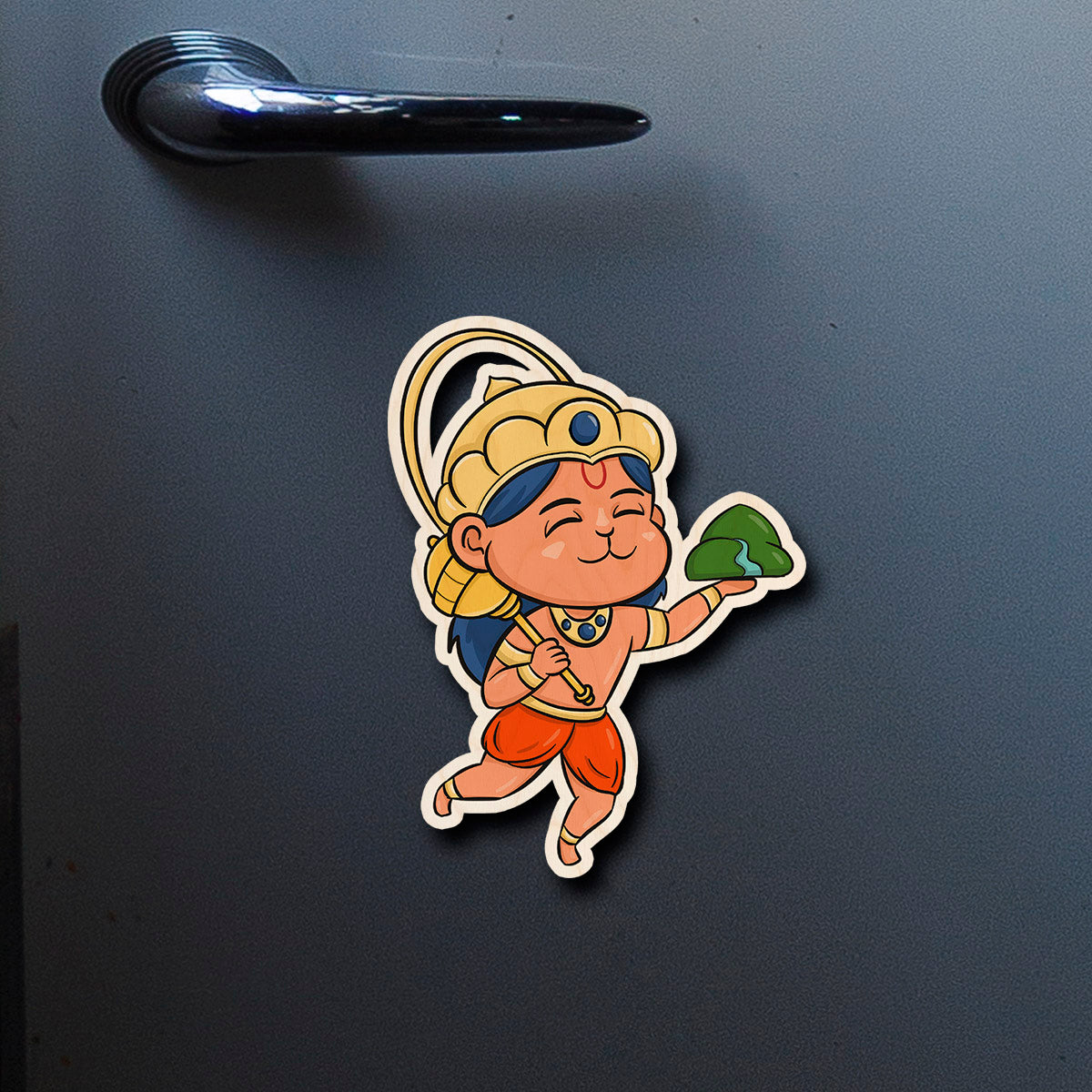 On-fridge lifestyle shot of the god fridge magnet, showing cartoon Hanuman with Sanjivani mountain and golden crown.