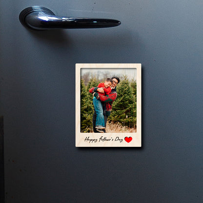 On-fridge lifestyle shot of the dad fridge magnet, showing polaroid with 'Happy Father's Day' cursive.