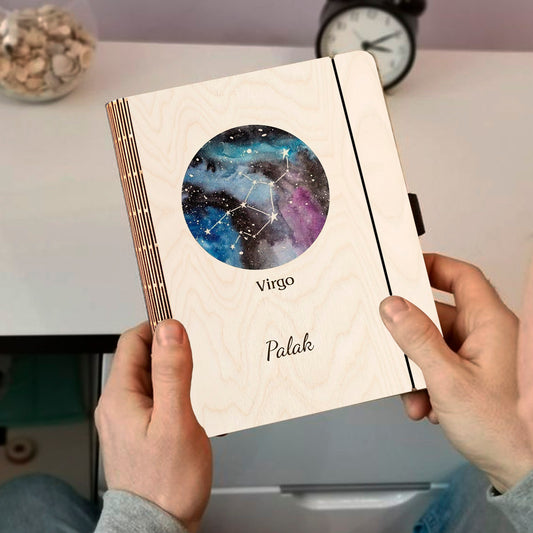 Personalized diary cover on a clean backdrop showing blue-purple nebula with Virgo constellation and custom name.