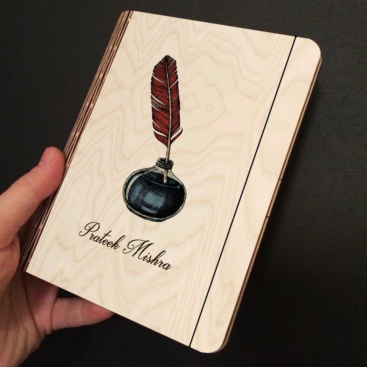 Open spread of the personalized diary, with color-printed quill + navy inkwell illustration with, and ruled inner pages.