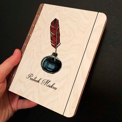 Open spread of the personalized diary, with color-printed quill + navy inkwell illustration with, and ruled inner pages.