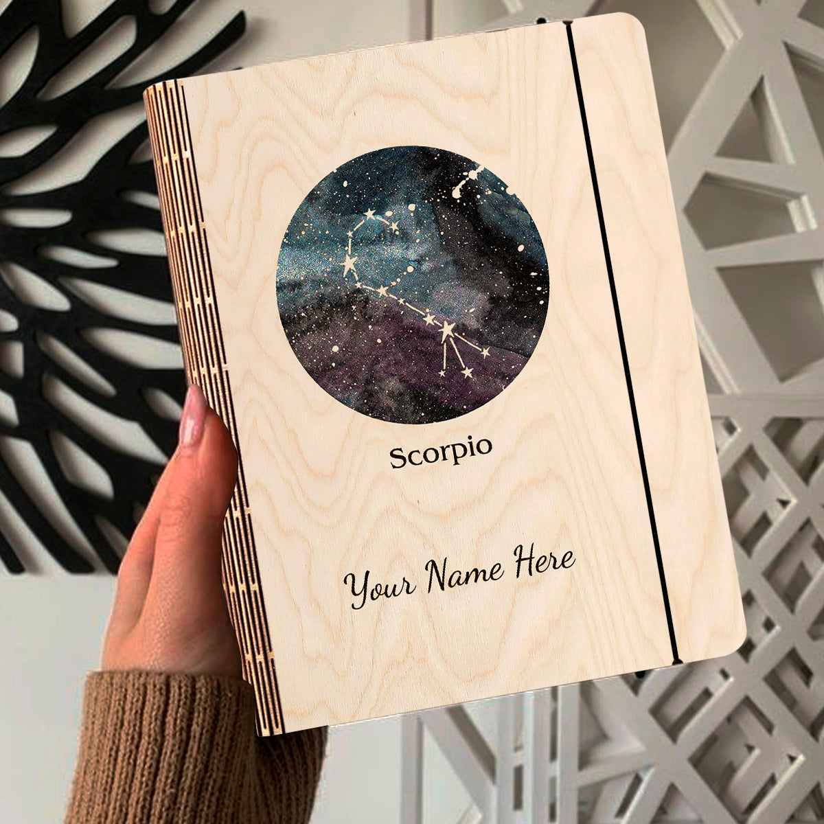 Open spread of the personalized diary, with blue-purple nebula with Scorpio constellation curl and, and ruled inner pages.