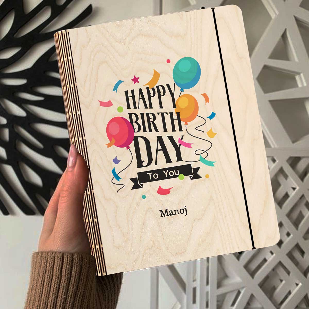 Alternate angle on the personalized diary, showing color-printed balloons + confetti with a custom name slot, in birch wood.