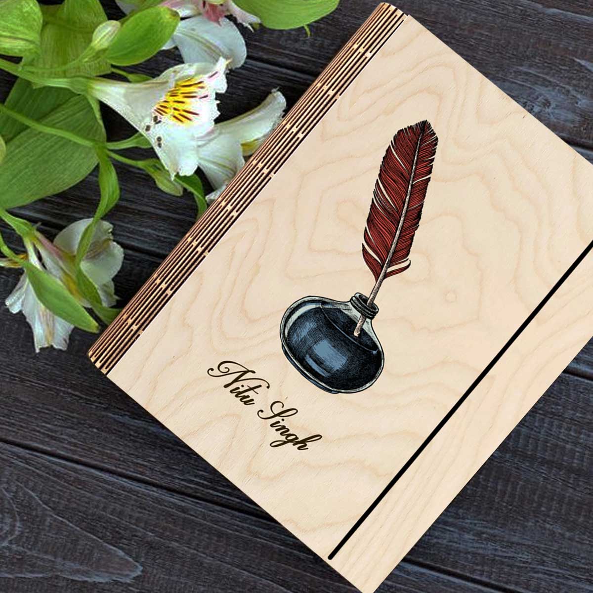 Personalized diary cover on a clean backdrop showing color-printed quill + navy inkwell illustration with.