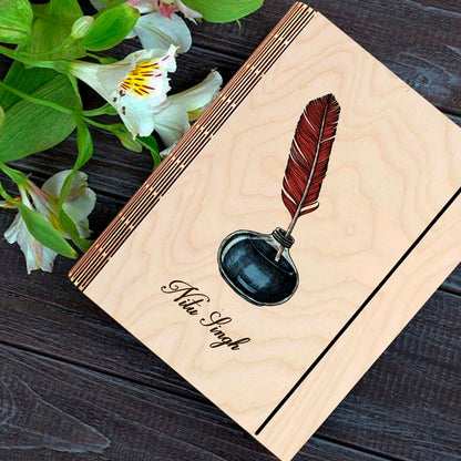 Personalized diary cover on a clean backdrop showing color-printed quill + navy inkwell illustration with.