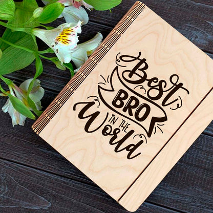 Wooden notebook cover on a clean backdrop showing hand-lettered brother-tribute script with ribbon banner.