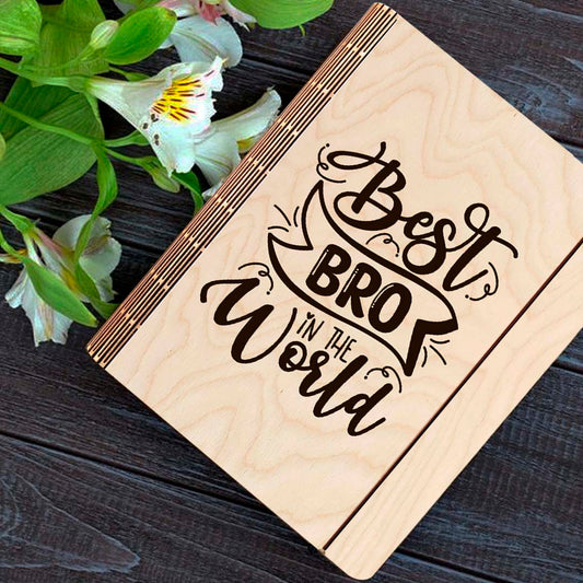 Wooden notebook cover on a clean backdrop showing hand-lettered brother-tribute script with ribbon banner.
