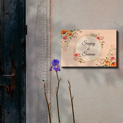 Close-up of bright red, coral and teal printed flowers framing the nameplate