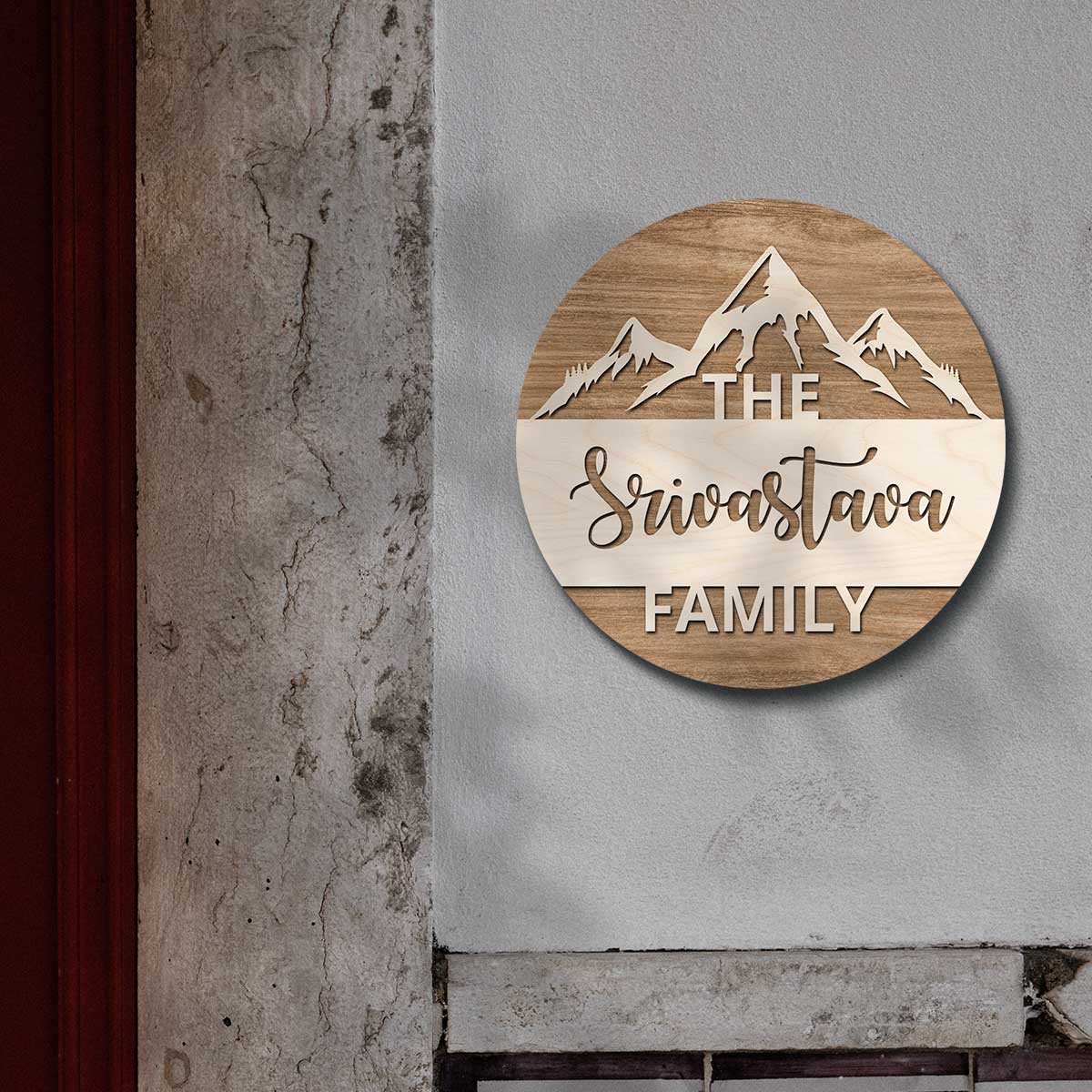 Close-up of the light wood mountain range and raised surname band on the nameplate