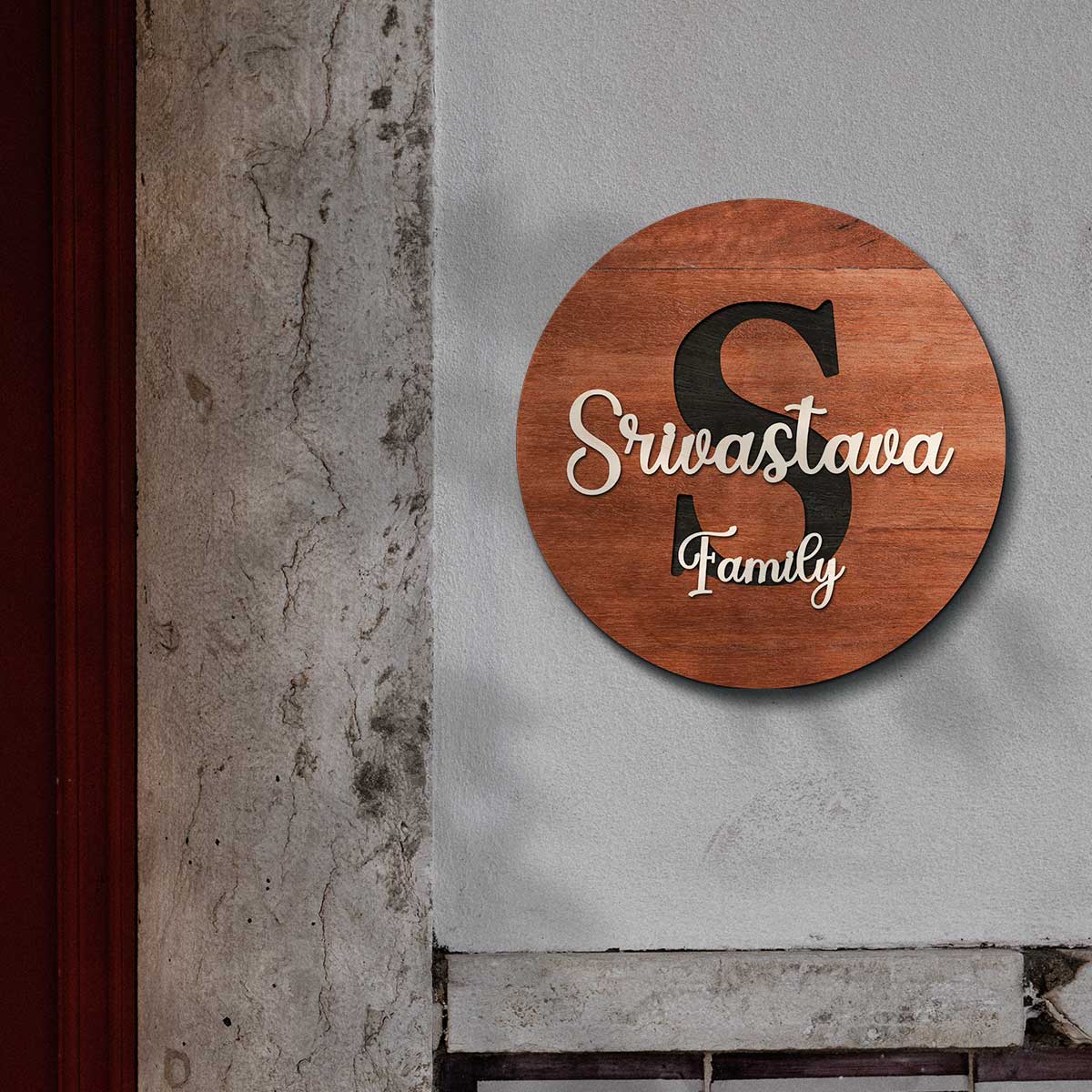 Close-up of large initial and raised 3D surname on round personalized name plate for home