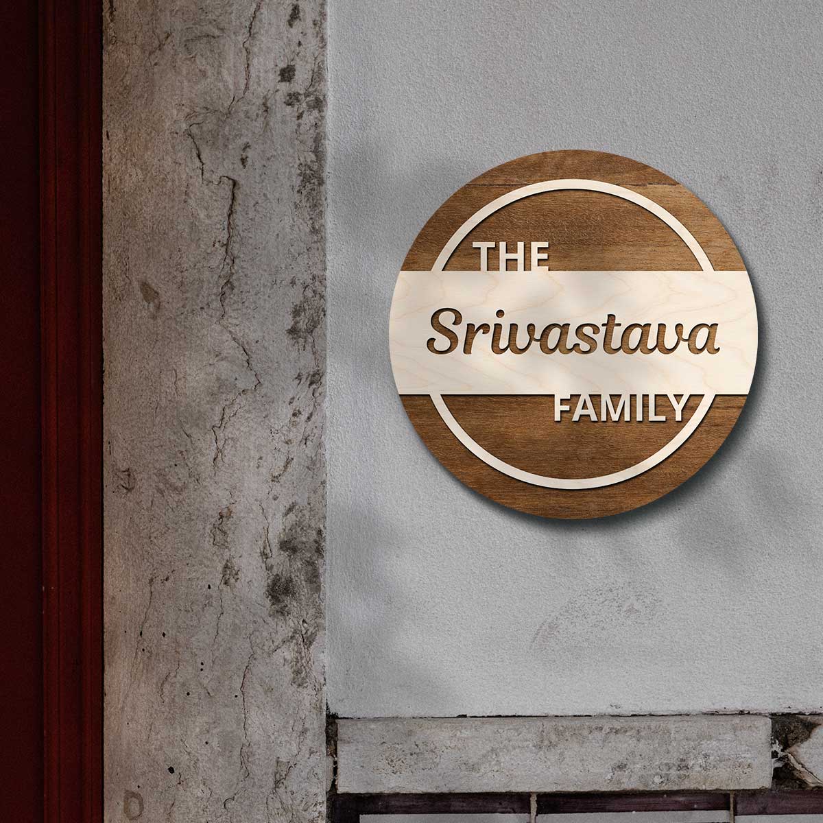 Close-up of the cut script surname and light wooden letters on the dark circle