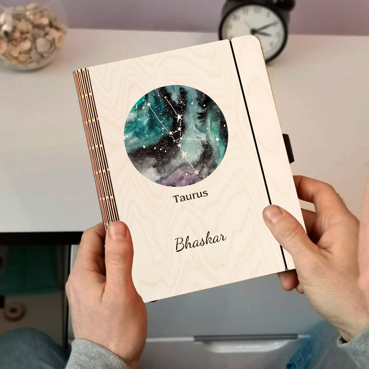 Personalized diary cover on a clean backdrop showing teal-blue nebula with Taurus V-shape Hyades cluster and.