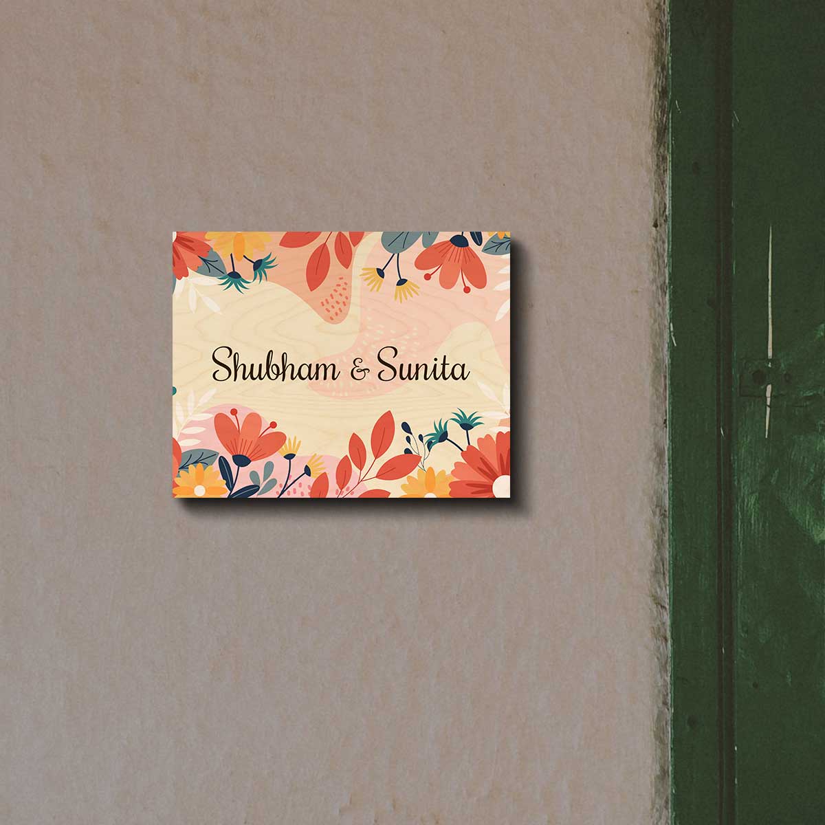 Printed floral name plate on a main door with a name in black script on birch