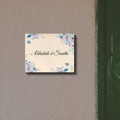 Name plate designs for flats with a name in cursive framed by purple watercolour flowers