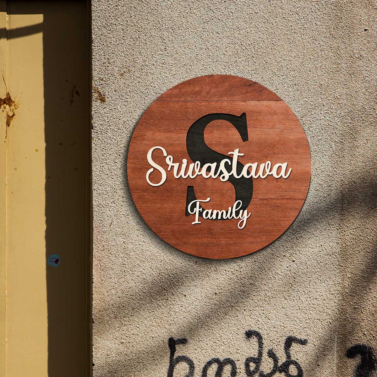 Round personalized name plate for home styled on apartment entrance with walnut monogram