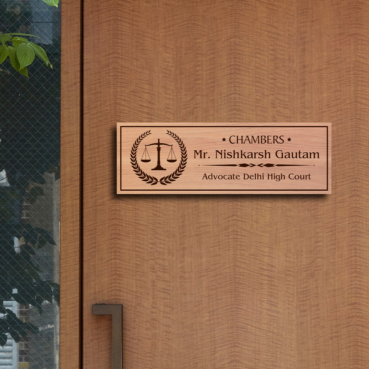 Outdoor advocate name plate with scales of justice in a laurel wreath and a name