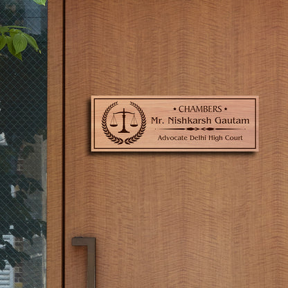Outdoor advocate name plate with scales of justice in a laurel wreath and a name