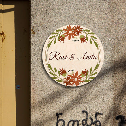 Floral round name board styled on apartment entrance with cream birch and wreath