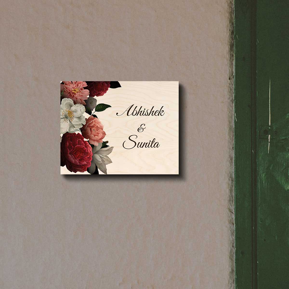 Peony name plate design with a red, pink and white bouquet beside two names in script