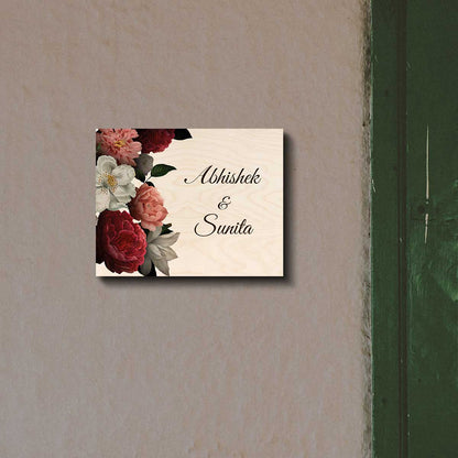 Peony name plate design with a red, pink and white bouquet beside two names in script