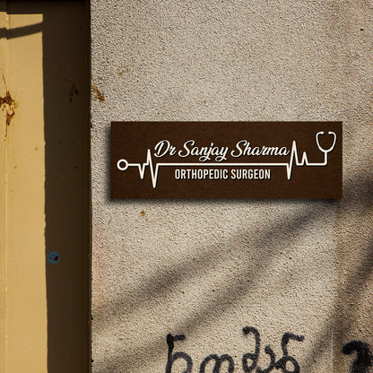 Heartbeat name plate with ECG line, stethoscope and doctor name in cream script