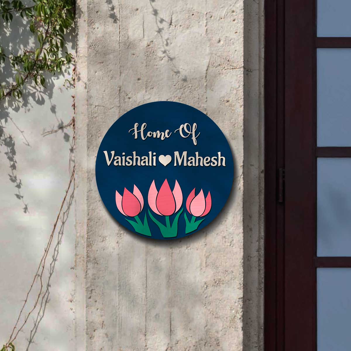 Makan ka name plate with raised Home Of text, two names and three pink tulips on navy