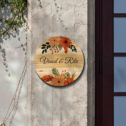 Close-up of boho floral motifs and berries on the round wooden nameplate over natural grain