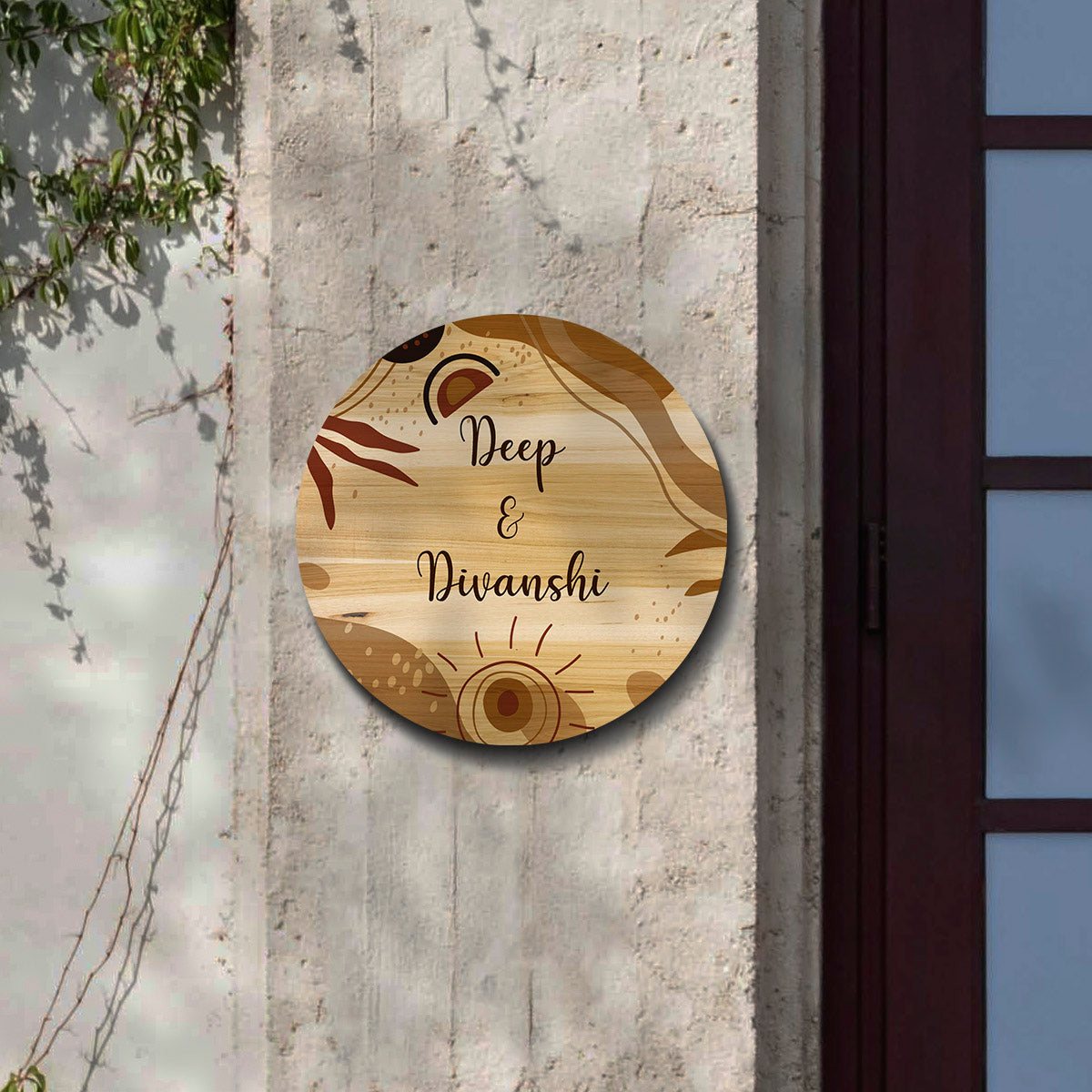 Close-up of rust and leaf motifs on round couple name plate for home