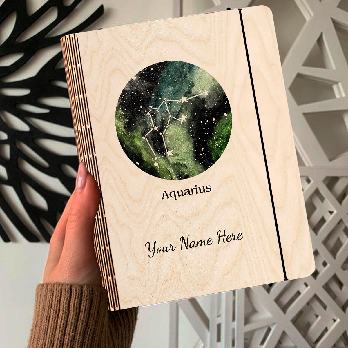 Open spread of the personalized diary, with green-blue-black nebula with Aquarius zigzag-wave, and ruled inner pages.