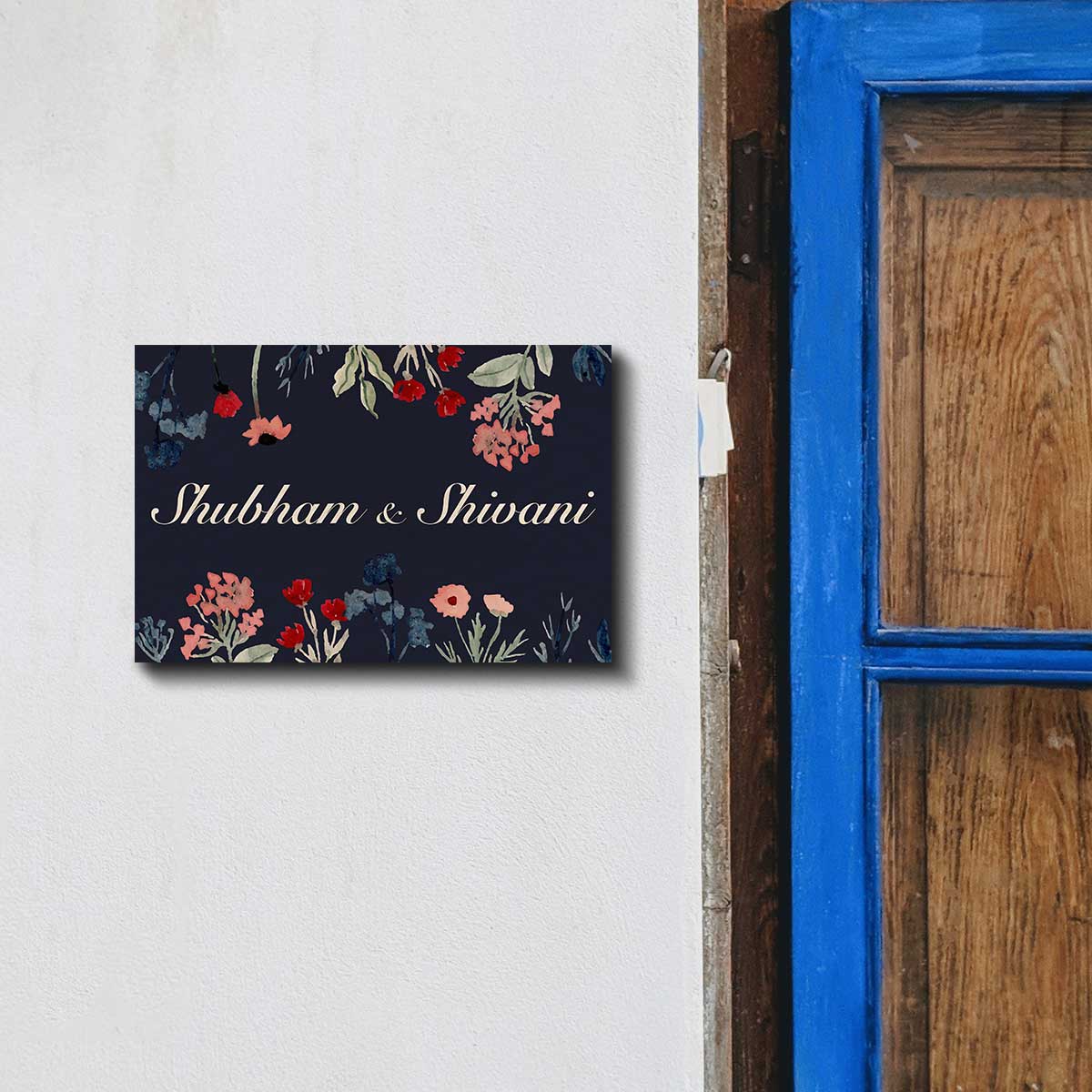 Close-up of wildflower print on navy dark floral couple name plate